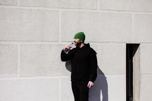 Thirsty jogger in active wear and holding water photo