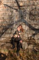 Lovely couple spending autumn day outdoors with their dog photo