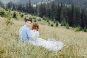 Photoshoot of the bride and groom in the mountains. Boho style wedding photo. photo