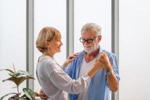 Portrait of happy senior couple dancing in living room, Elderly woman and a man dancing, Happy family concepts photo