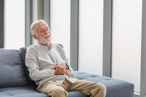 Portrait of happy senior man in living room, Smiling elderly caucasian old man photo