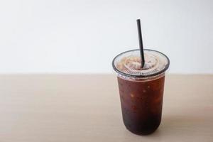 Iced Americano black coffee cup on the table in a coffee shop photo