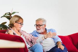 Portrait of happy senior couple in living room, Elderly woman and a man relaxing on cozy sofa at home, Happy family concepts photo