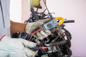 Auto mechanic working in mechanics garage, Technician checking a car engine, Repair and Maintenance service photo