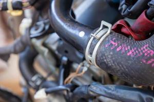 Spring hose clamps on the rubber tube of the car engine photo