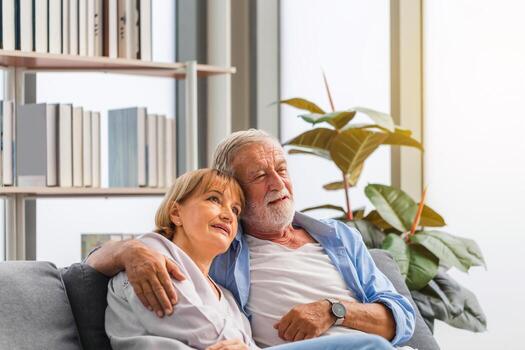 Happy senior couple in living room, Elderly woman and a man relaxing on cozy sofa at home, Happy family concepts photo