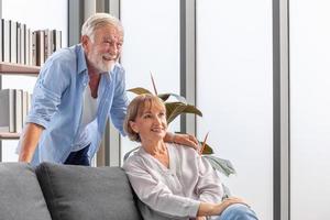 Happy senior couple in living room, Elderly woman and a man relaxing on cozy sofa at home, Happy family concepts photo