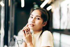 Closeup portrait of young adult asian business woman in office on day photo