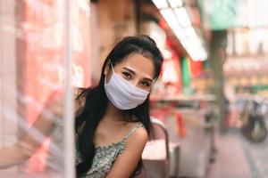 Happy asian adult woman wear protect mask for new normal life. photo