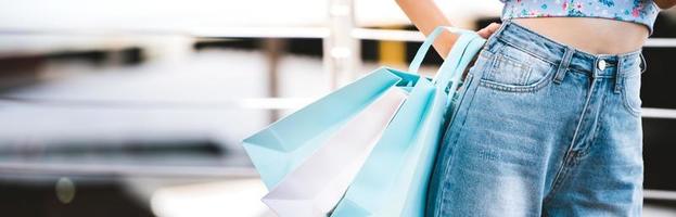 woman shopping with blue bags banner background photo