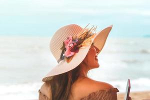 Holiday solo traveler beautiful smile woman relax at the beach. photo