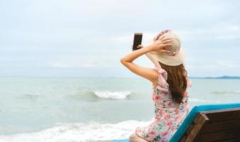 Asian travel blogger woman reading comment on social network. photo