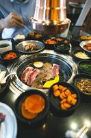 Korea bbq style restaurant  with meat and vegetable side diesh. photo