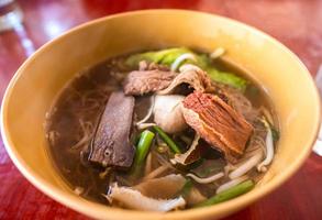 Clear herb beef soup with noodle. photo