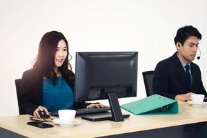 Cute asian working woman on support call center business department. photo