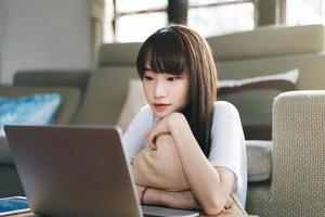 Asian teenager woman work and study online via internet at home. photo