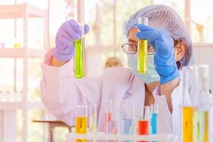 An Asian female scientist is researching a chemical formula in a lab. photo