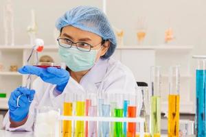 An Asian female scientist is researching a chemical formula in a lab. photo