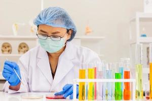 An Asian female scientist is researching a chemical formula in a lab. photo