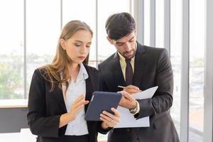 Two business men and women standing meeting in the office photo