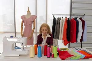 Professional female sewing designers in the office have a variety of fabric color schemes. photo