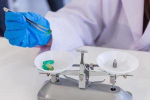 Asian female scientist is holding the medicine in a science lab. She is doing experiment and research. photo