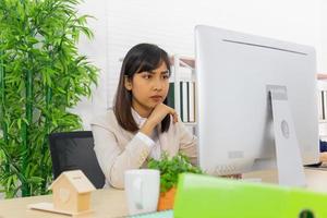 Asian business women sit and work in the office with diligence, determination photo