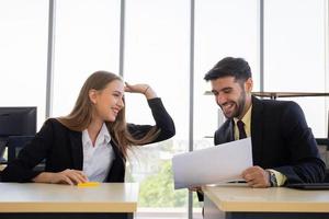 Two young business men, men and women, Dew, work at the office with fun photo