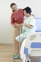 Asian women take care of elderly women beside the hospital bed photo