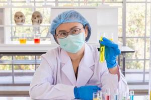 An Asian female scientist is researching a chemical formula in a lab. photo