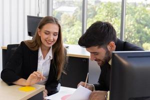 Two young business men, men and women Dew, work at the office with happiness photo