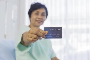 Concept of elderly women using credit cards in hospitals photo