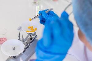 An Asian female scientist is researching a chemical formula in a lab. photo