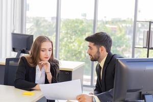 Two young business men, men and women Dew, work at the office with happiness photo