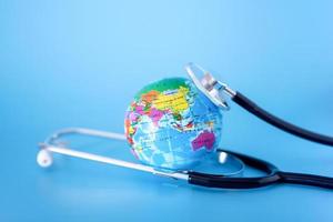 Stethoscope and planet earth on a blue background. Green Earth Day, photo