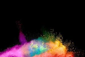 Abstract colorful powder explosion on black background.Freeze motion of dust splash.Painted Holi. photo