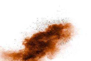Brown dust exploding cloud.Brown particles splattered on white background. photo