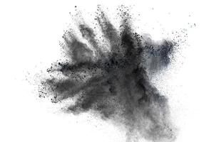 Black powder explosion against white background.The particles of charcoal splattered on white background. photo