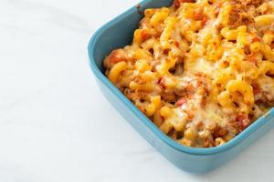 homemade macaroni bolognese with cheese photo