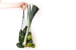 Green fruits and vegetables in net eco bag photo