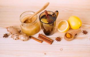 Cup warm water with lemon, honey, ginger, cinnamon and anise. photo