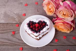 Heart shaped cake decorated with red currant photo