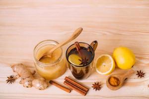 Cup warm water with lemon, honey, ginger, cinnamon and anise. photo