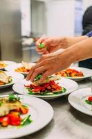 Meat dish with vegetables for catering. Lots of plates. photo