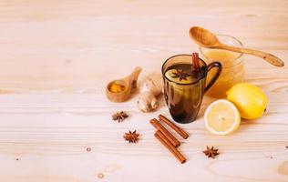 Cup warm water with lemon, honey, ginger, cinnamon and anise. photo