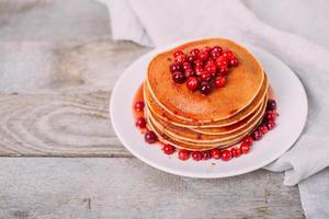 Tasty and bright pancakes with cranberries. photo