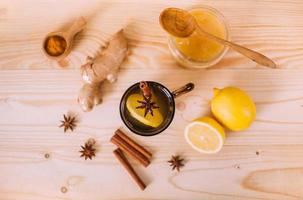 Cup warm water with lemon, honey and ginger root. photo