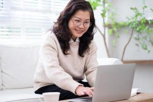 Image of senior Asian businesswoman working at home photo
