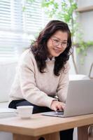 Image of senior Asian businesswoman working at home photo