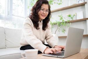 Image of senior Asian businesswoman working at home photo